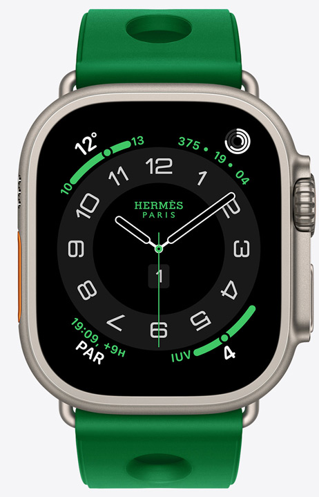 Apple Watch Hermès Ultra 4, esfera analógica Circulaire, (aguja horaria, minutero y segundero, complicaciones: Tiempo, anillos de Actividad, hora de París e Índice UV), caja de titanio, color natural, lateral derecho, Digital Crown, botón lateral elevado, con la correa Scub'H Diving, color Vert Vertigo (verde brillante), fabricada en goma moldeada, aberturas circulares en el centro