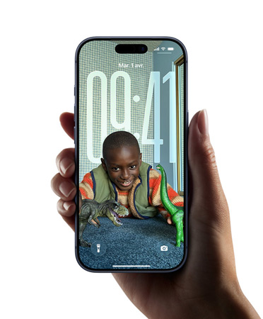 Une main tenant un appareil iPhone affichant le nouveau design Liquid Glass qui permet à l’heure de s’adapter automatiquement à l’image sur l’écran verrouillé