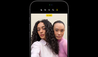 ブラックのiPhone 18 Proを正面から見た図。センターフレームフロントカメラ機能で、2人の人物の顔を追尾している様子