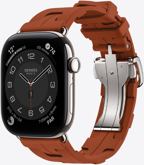 ساعة Apple Watch Hermès Series 12، واجهة الساعة بعقارب Circulaire، (عقارب الساعة والدقيقة والثانية، الإضافات: الطقس، والضوضاء، وحلقات النشاط، والوقت في باريس)، إطار تيتانيوم، لون فضي، الجهة الخارجية اليمنى، التاج الرقمي، زر جانبي، مقترنة بحزام Kilim Single Tour، لون cuivre (بني)، مطاط مقولب، تصميم متشابك، إبزيم معدني بلون فضي