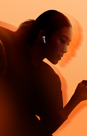 A person wearing AirPods 5, arms bent, multi-color background