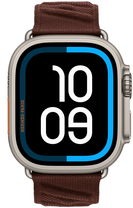 Apple Watch Hermès Ultra 4, Maritime digital watch face, titanium case, natural color, right side exterior, Digital Crown, raised side button, paired with En Mer band, Bordeaux color (dark brown), textured knit material