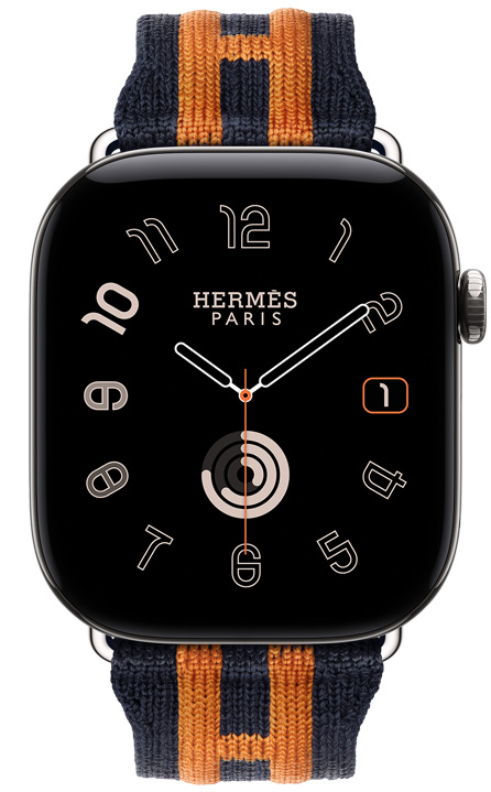 Apple Watch Hermès Series 12, Radial analog watch face, (hour, minute and second hands, complications: date, Activity rings), titanium case, silver color, right side exterior, Digital Crown, raised side button, paired with Rocabar Club band, Bleu Nuit/Orange color, dark blue knit material with orange raised striped design that incorporates the Hermès H