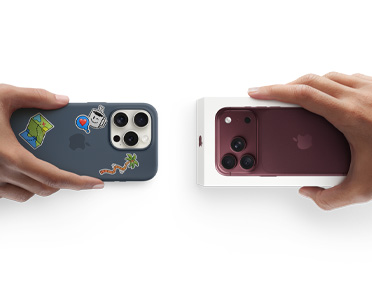 Hands exchanging trade-in. Older iPhone in a case with stickers for a new Burgundy iPhone 18 Pro in the box.