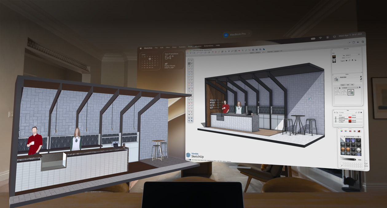 Apple Vision Pro view, MacBook Pro sits on a surface with 3D models projected behind it, models show a cafe service counter with two people standing behind it
